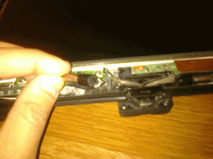 A very blurry picture of the broken hinge.